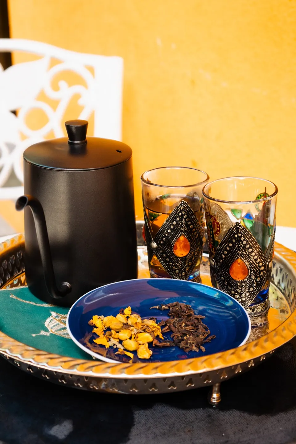 Moroccan tea glasses and a teapot on a brass tray